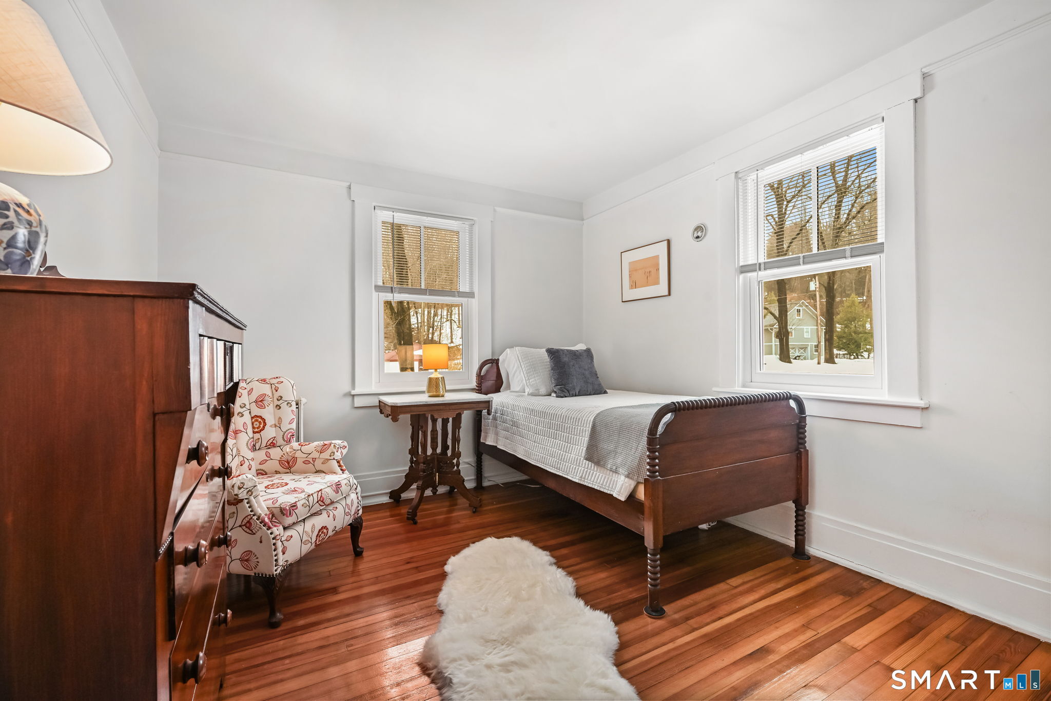 32 Catalpa Road Wilton, CT 06897 - Photo 22 of 36 a bedroom with a bed and wooden floor