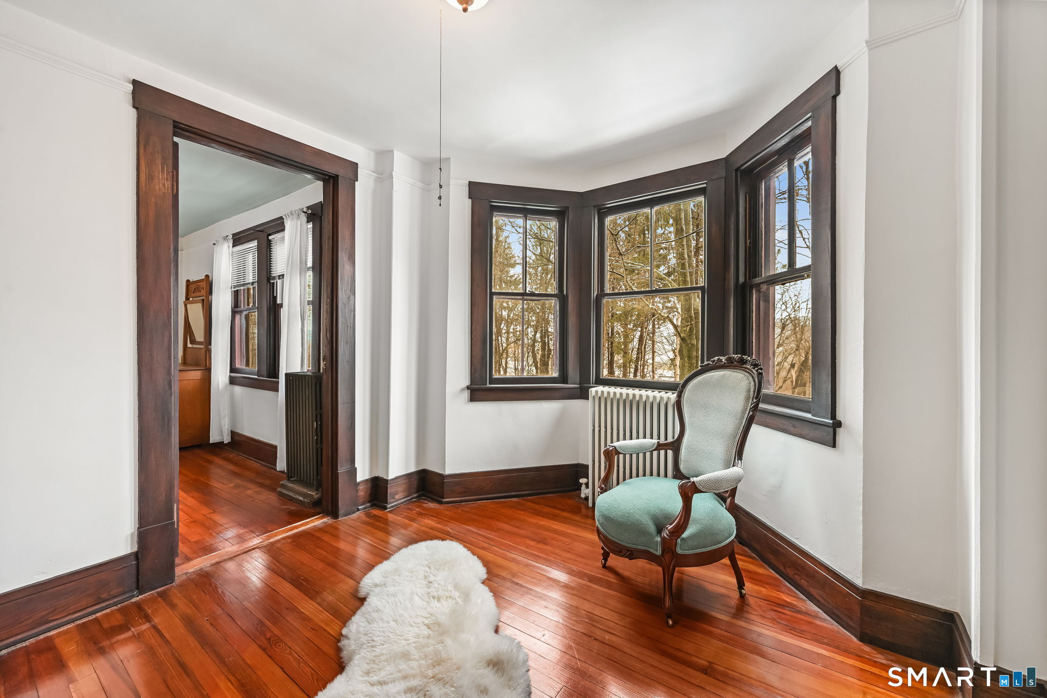 32 Catalpa Road Wilton, CT 06897 - Photo 23 of 36 a bedroom with a bed and a chair