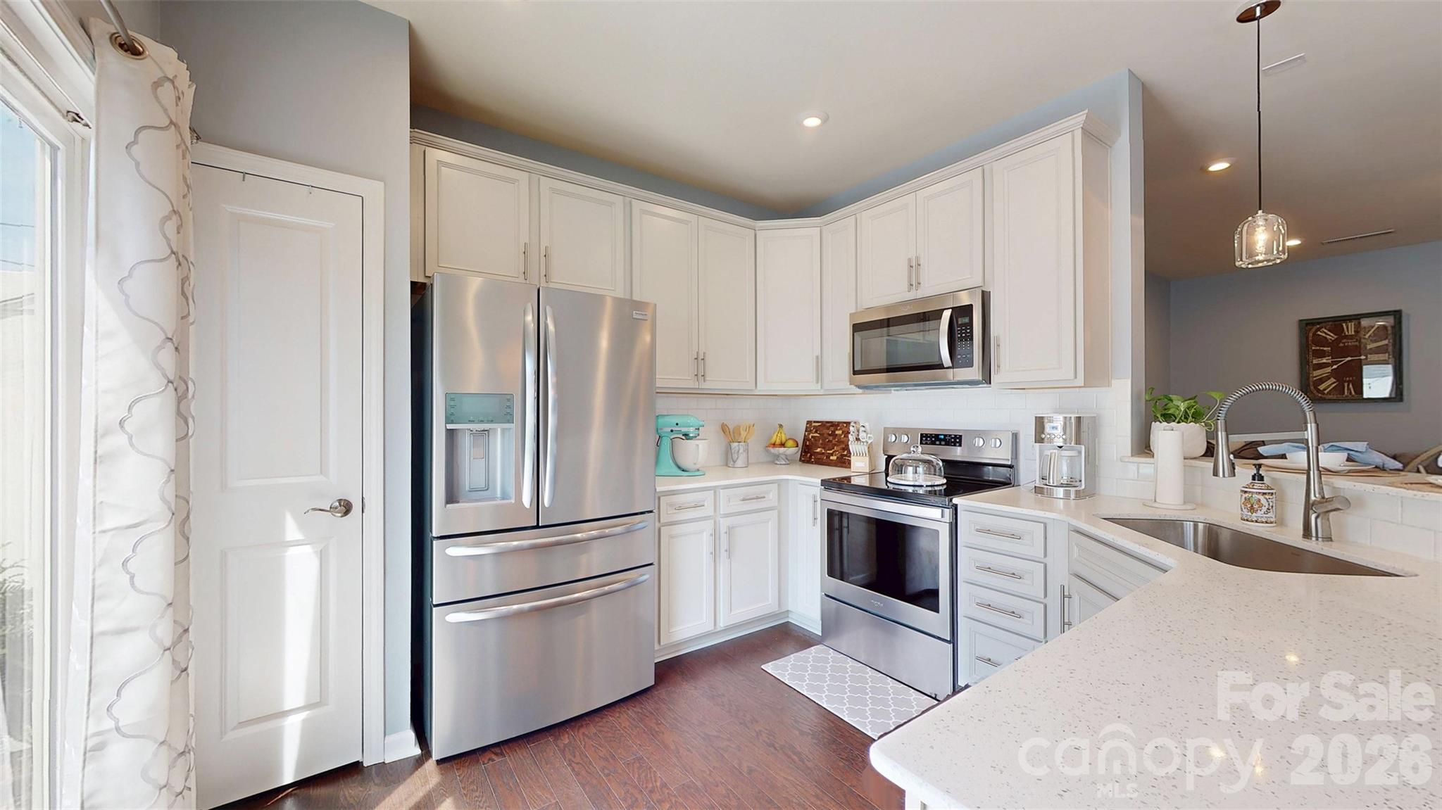827 Canoe Song Road Fort Mill, SC 29708 - Photo 13 of 33 a kitchen with granite countertop stainless steel appliances and wooden floor