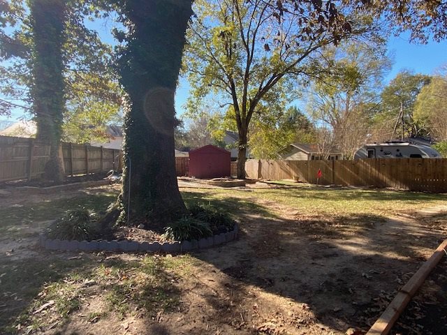 6519 Messick Road Memphis, TN 38119 - Photo 22 of 23 Large back yard with gorgeous trees, storage shed, fire pit, and new wood fence.