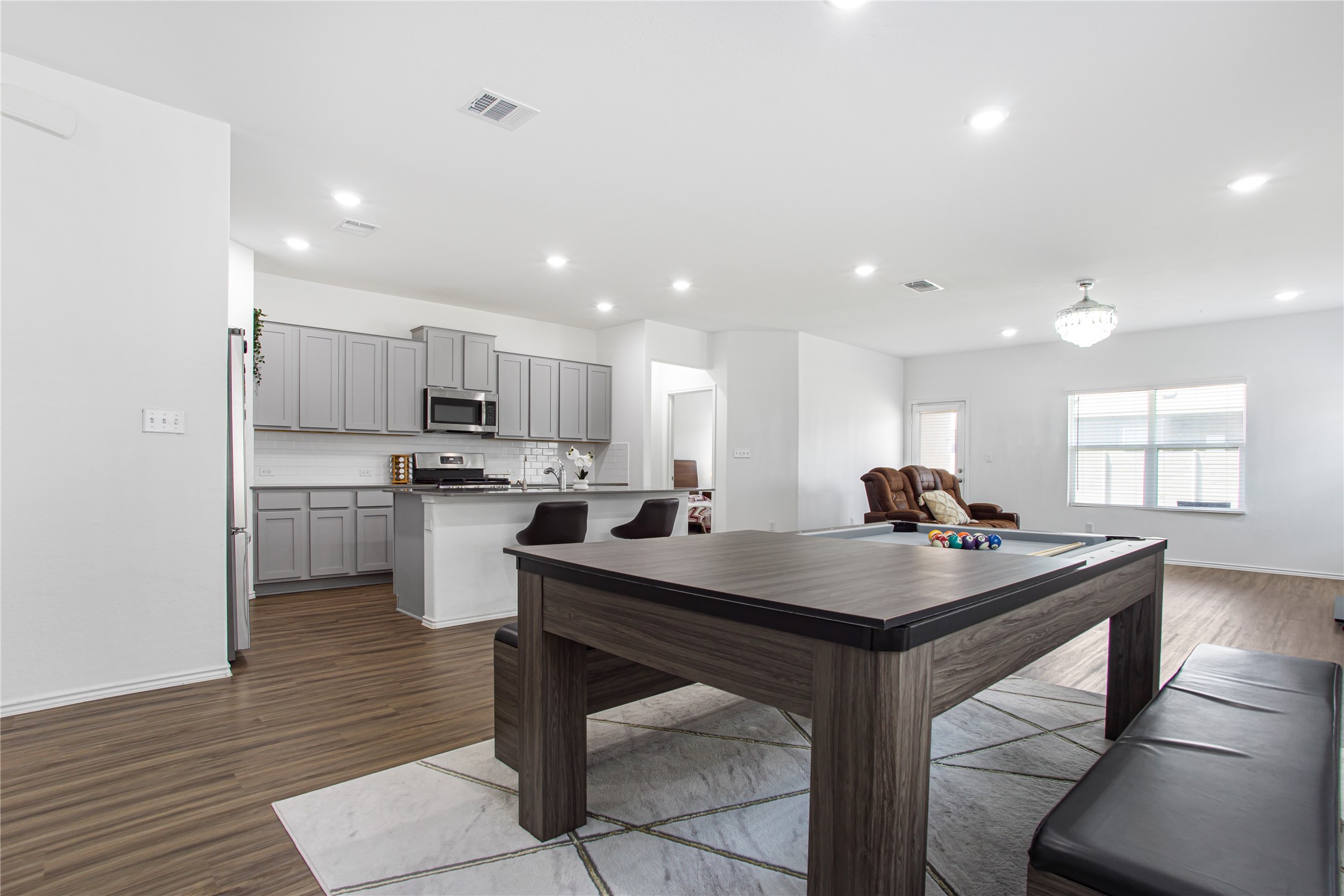 124 Cherry Ridge Road Georgetown, TX 78628 - Photo 7 of 23 Open-concept living area featuring wood-finish flooring, recessed lighting, and a white color palette