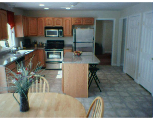 3 Flaxfield Road Dudley, MA 01571 - Photo 2 of 6 a kitchen with stainless steel appliances granite countertop a stove a refrigerator and a microwave
