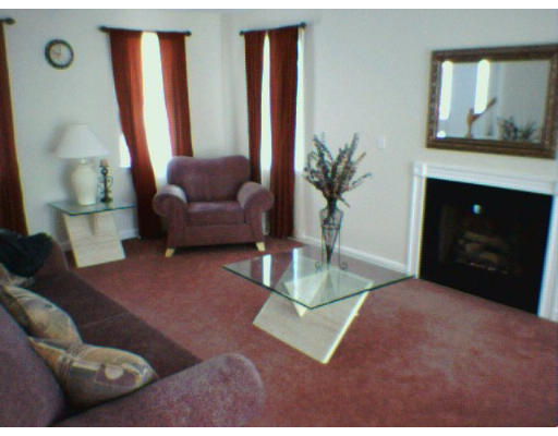 3 Flaxfield Road Dudley, MA 01571 - Photo 3 of 6 a living room with furniture and a fireplace