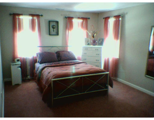 3 Flaxfield Road Dudley, MA 01571 - Photo 4 of 6 a bedroom with a bed and a window