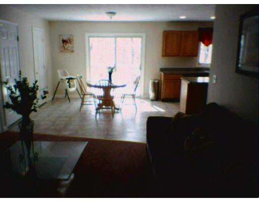 3 Flaxfield Road Dudley, MA 01571 - Photo 6 of 6 a living room with furniture wooden floor and a flat screen tv