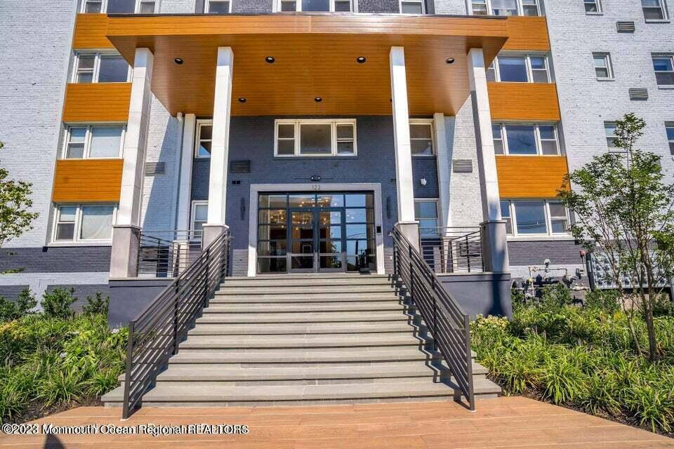 122 Bodman Place, Unit 1E Red Bank, NJ 07701 - Photo 5 of 23 a view of a brick building with many windows