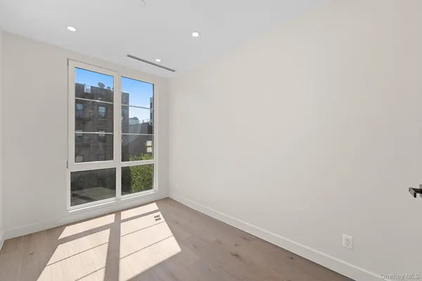 a view of a small space with wooden floor and a window