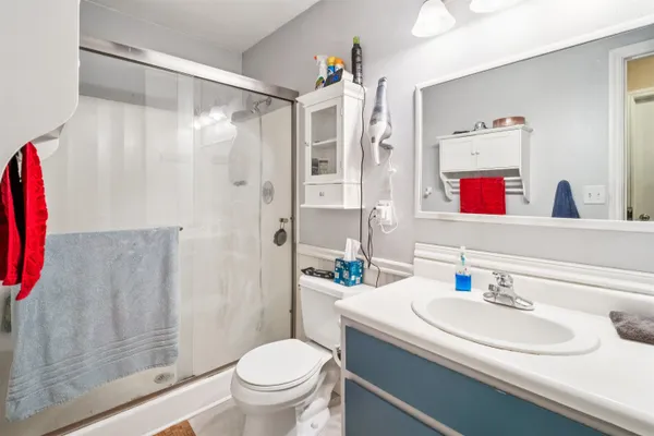 a bathroom with a shower toilet and sink