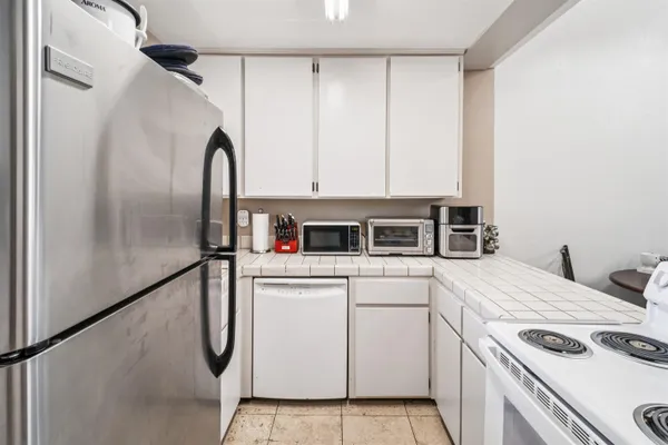a kitchen with a white cabinets and white appliances