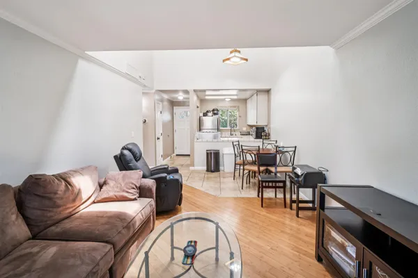 a living room with furniture and wooden floor
