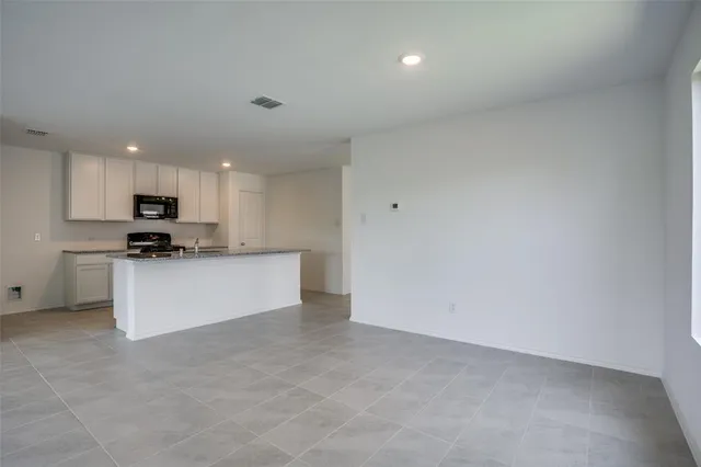 a view of kitchen with kitchen island sink stainless steel appliances and cabinets