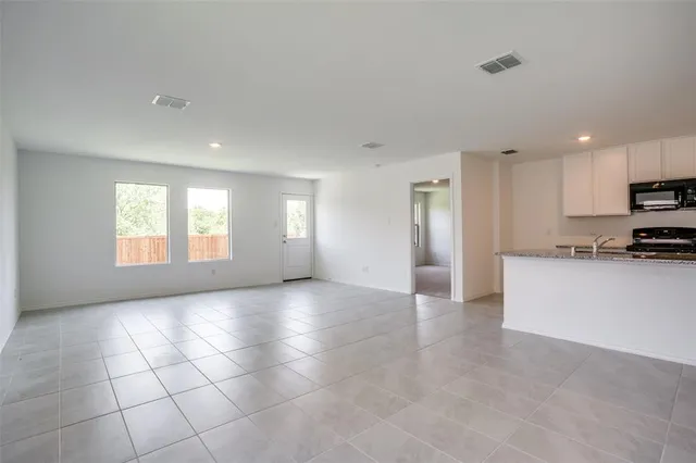a view of a kitchen with a sink and a window