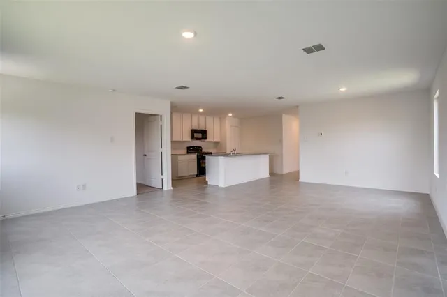 a view of a kitchen with a sink and a refrigerator