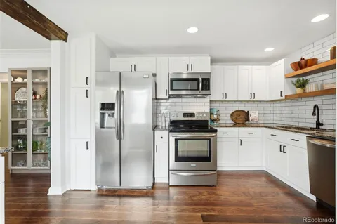 a kitchen with stainless steel appliances a refrigerator stove and sink