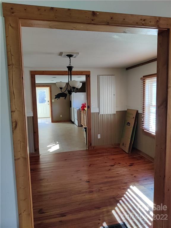 903 Middlefork Road Brevard, NC 28712 - Photo 8 of 11 a view of a livingroom with a chair and wooden floor