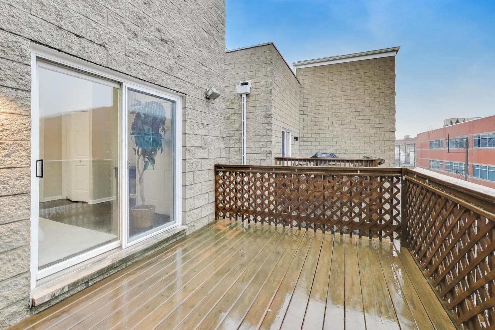 1312 West Fletcher Street, Unit 3W Chicago, IL 60657 - Photo 12 of 30 a view of a balcony with wooden floor