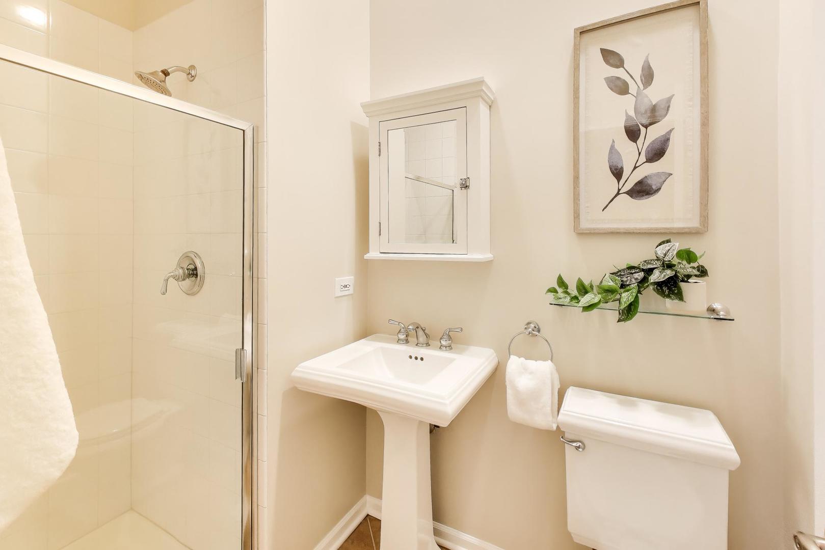 1312 West Fletcher Street, Unit 3W Chicago, IL 60657 - Photo 18 of 30 a bathroom with a sink a toilet and a mirror