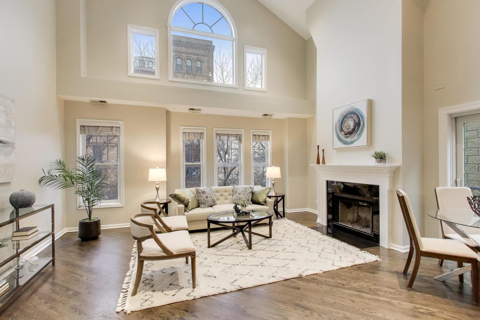 1312 West Fletcher Street, Unit 3W Chicago, IL 60657 - Photo 2 of 30 a living room with furniture a fireplace and potted plants
