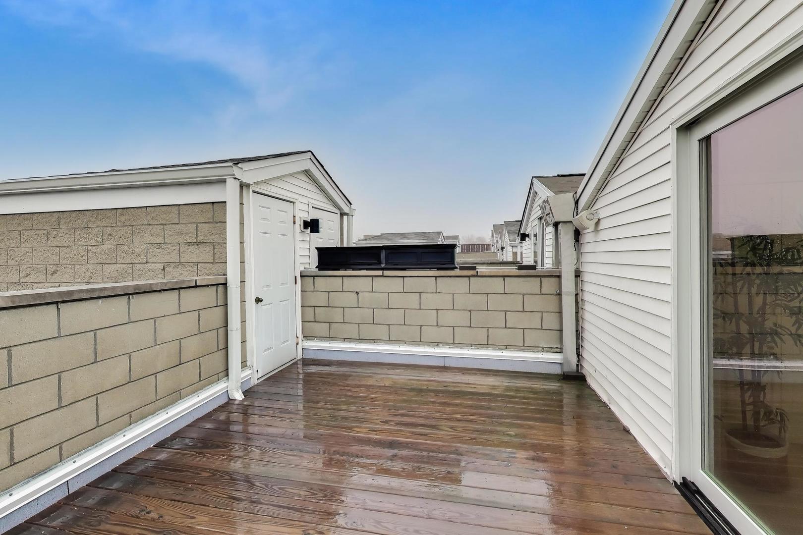 1312 West Fletcher Street, Unit 3W Chicago, IL 60657 - Photo 27 of 30 a view of a balcony with wooden floor and cabinet