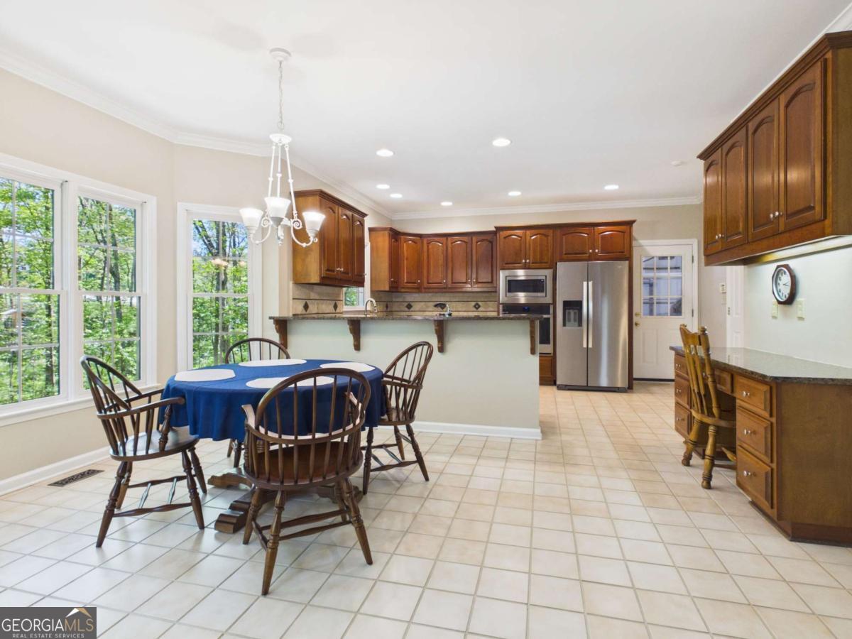 1120 Laurel Pointe Watkinsville, GA 30677 - Photo 11 of 50 a view of a dining room with furniture window and outside view