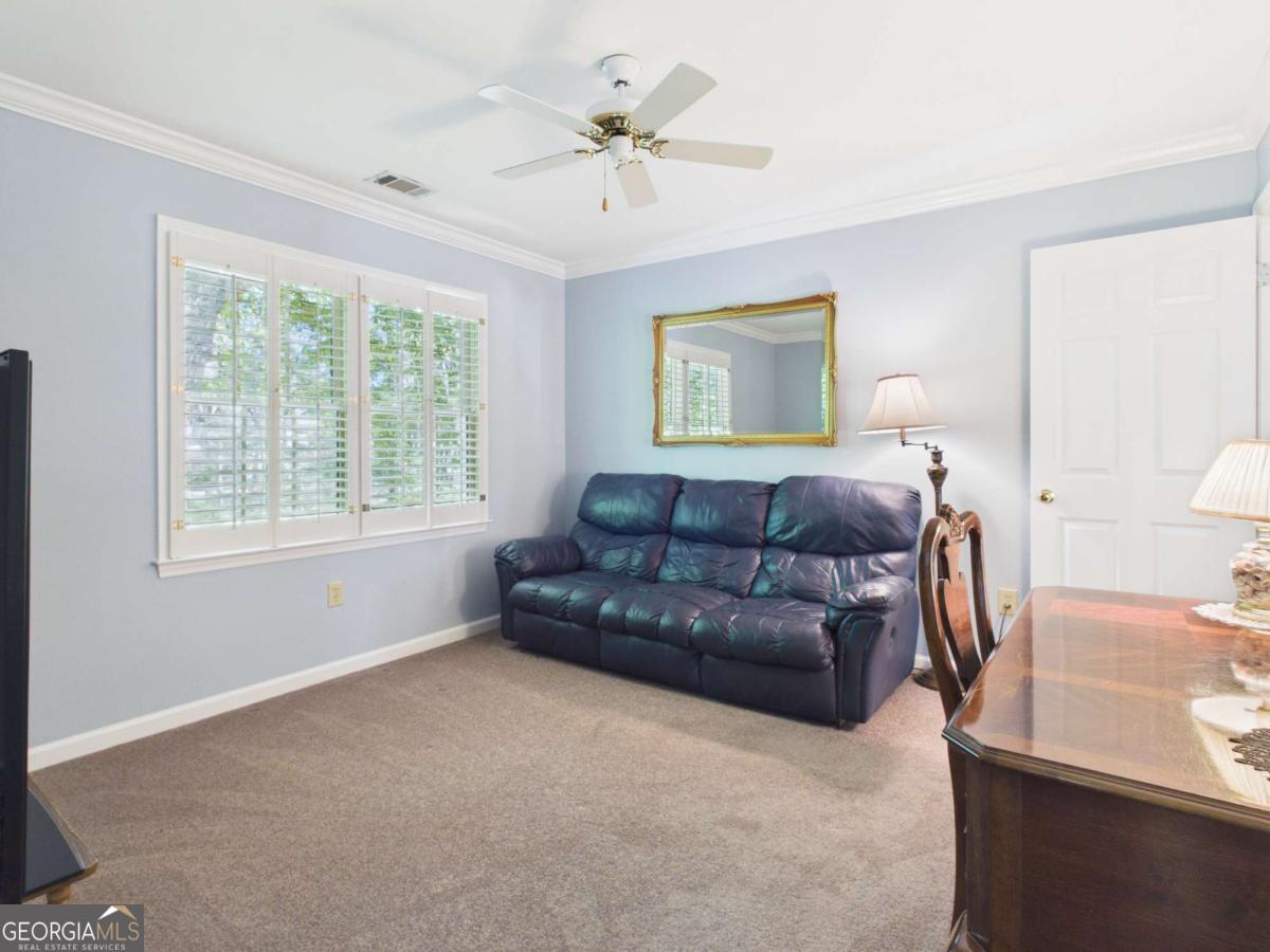 1120 Laurel Pointe Watkinsville, GA 30677 - Photo 20 of 50 a living room with a couch and a chandelier