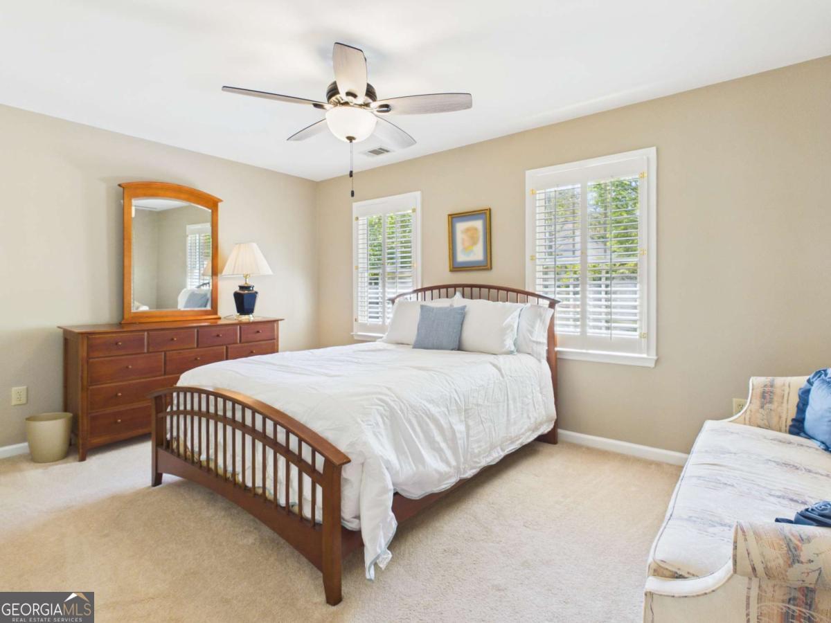 1120 Laurel Pointe Watkinsville, GA 30677 - Photo 28 of 50 a bedroom with a bed and a chandelier