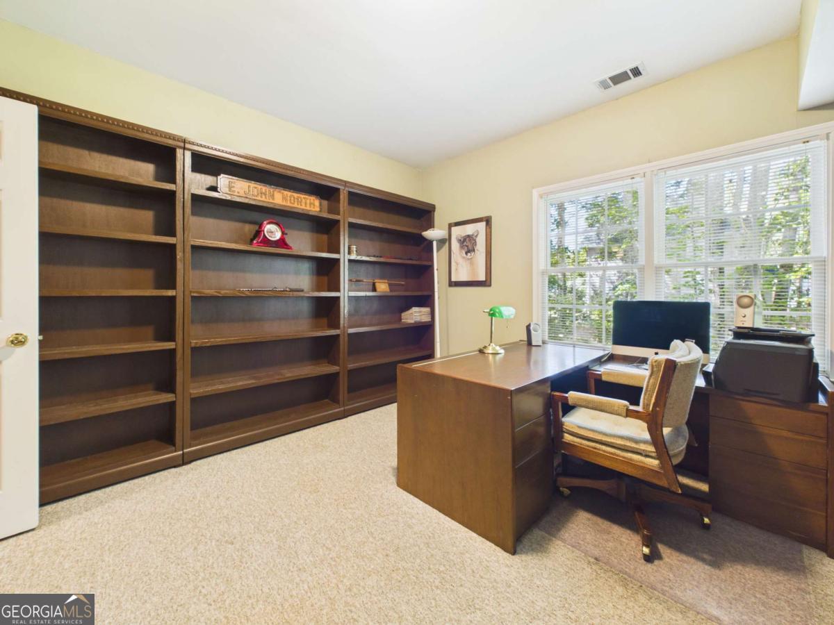 1120 Laurel Pointe Watkinsville, GA 30677 - Photo 35 of 50 a living room with furniture cabinets and a window