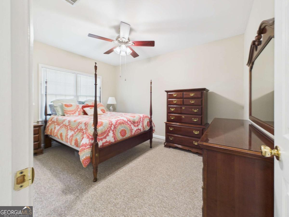 1120 Laurel Pointe Watkinsville, GA 30677 - Photo 40 of 50 a bedroom with a bed and a chandelier