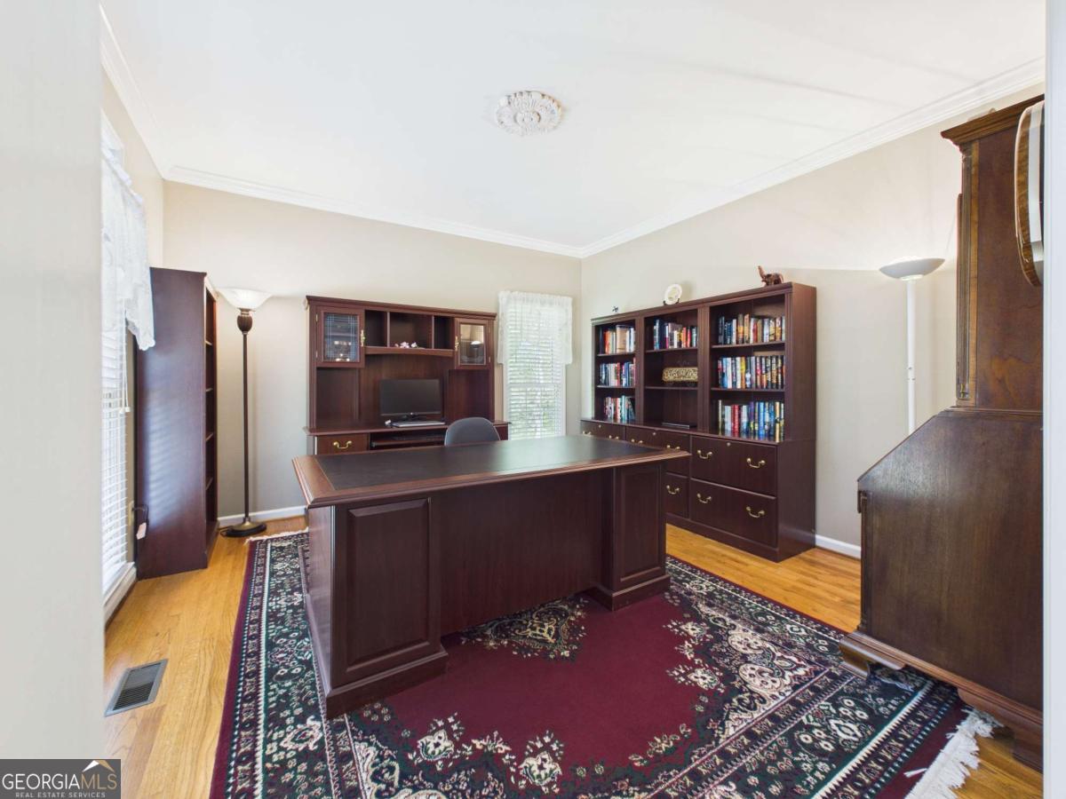 1120 Laurel Pointe Watkinsville, GA 30677 - Photo 4 of 50 a living room with a couch and a bookshelf