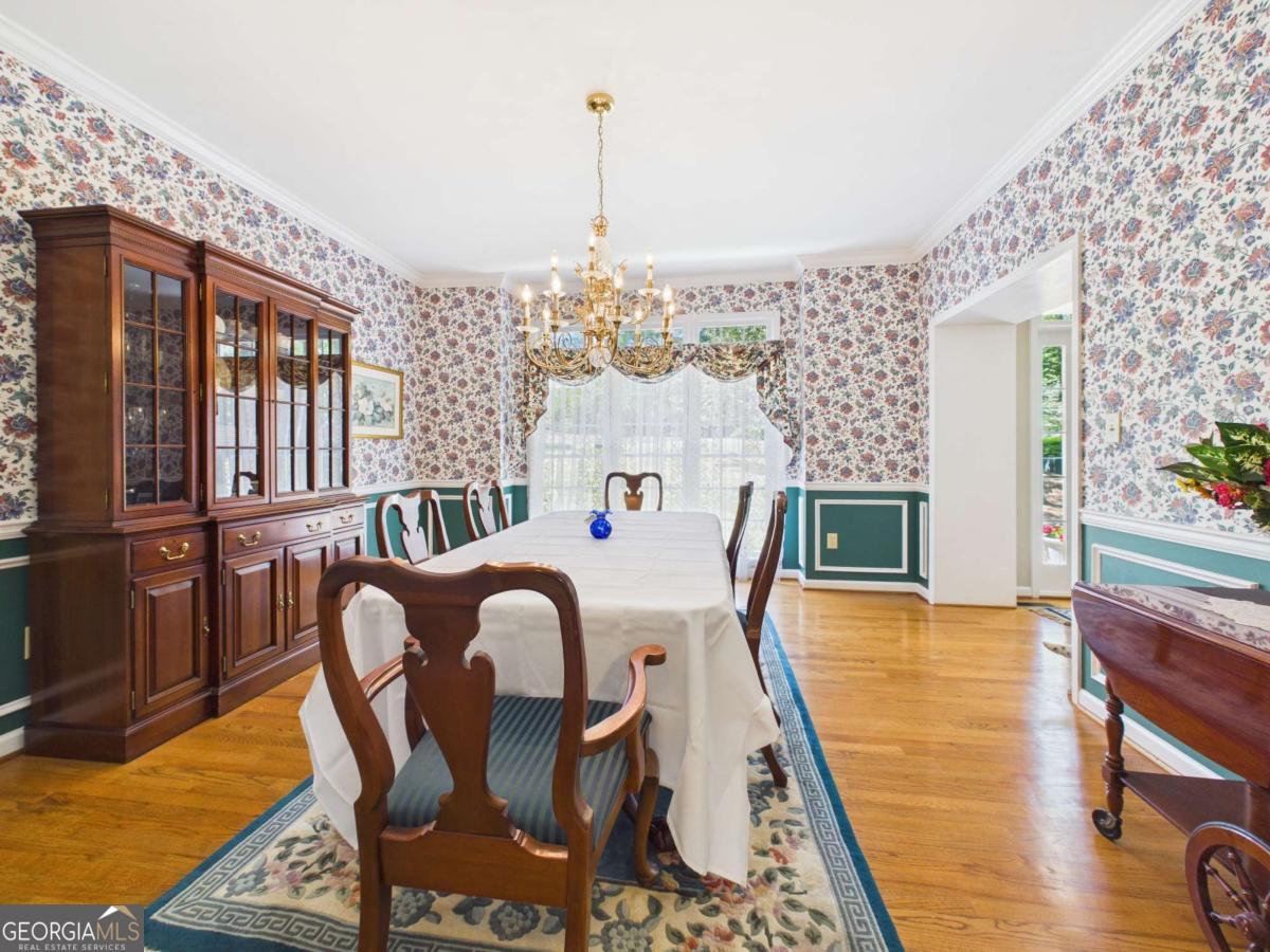 1120 Laurel Pointe Watkinsville, GA 30677 - Photo 6 of 50 a dining room with furniture a chandelier and wooden floor