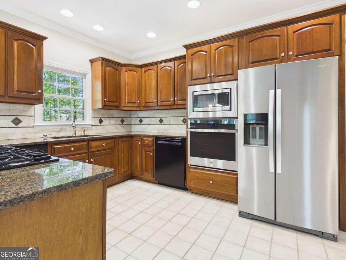 1120 Laurel Pointe Watkinsville, GA 30677 - Photo 9 of 50 a kitchen with stainless steel appliances granite countertop a refrigerator and a stove top oven