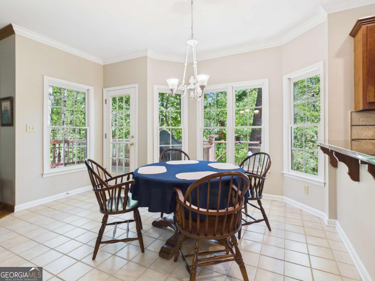 1120 Laurel Pointe Watkinsville, GA 30677 - Photo 10 of 50 a view of a dining room with furniture large windows and wooden floor