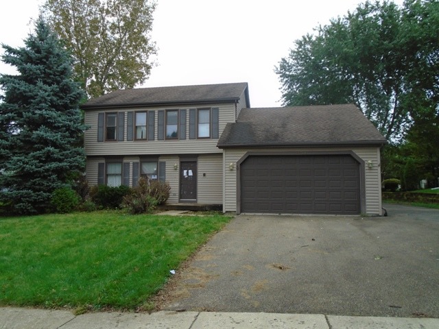 706 Hunters Way Fox River Grove, IL 60021 - Photo 1 of 17 a front view of a house with a yard and garage