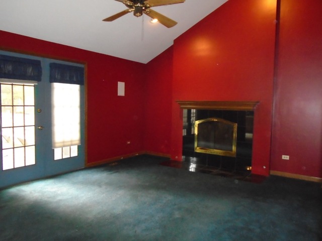 706 Hunters Way Fox River Grove, IL 60021 - Photo 5 of 17 an empty room with windows and fireplace