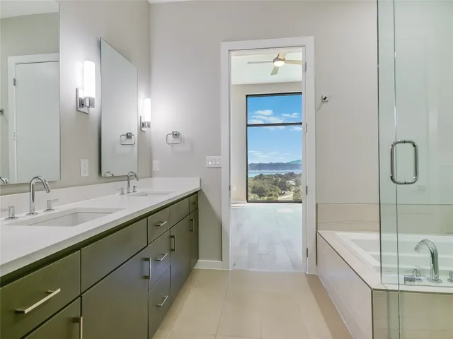 a bathroom with a granite countertop sink a bathtub and shower
