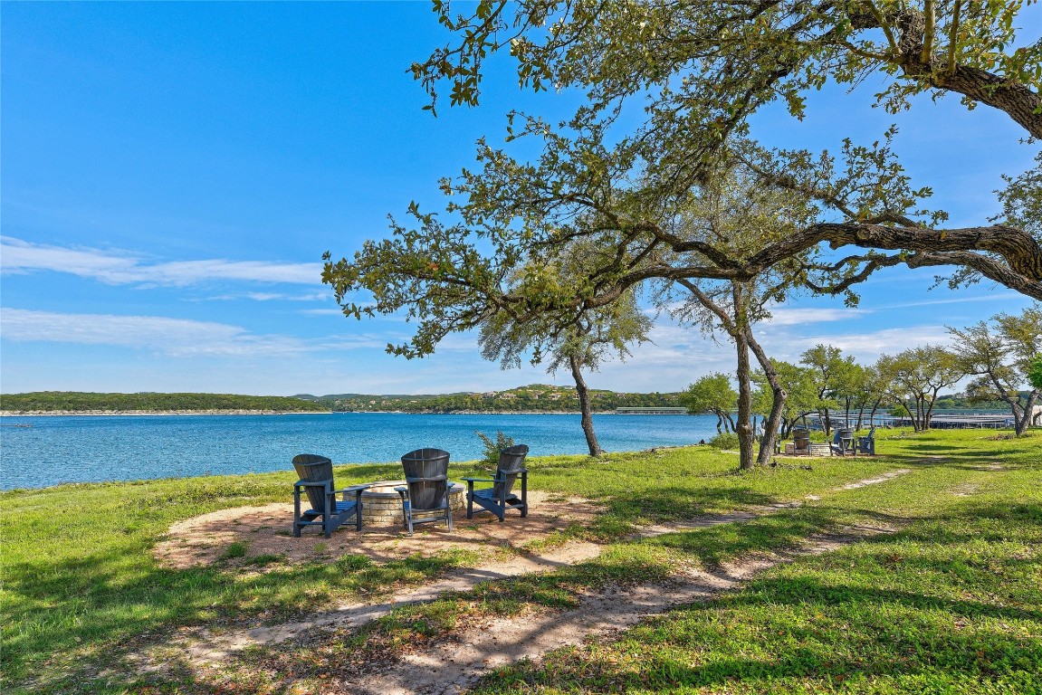 5921 Hiline Road, Unit 2402 Austin, TX 78734 - Photo 25 of 31 a view of a lake with a yard
