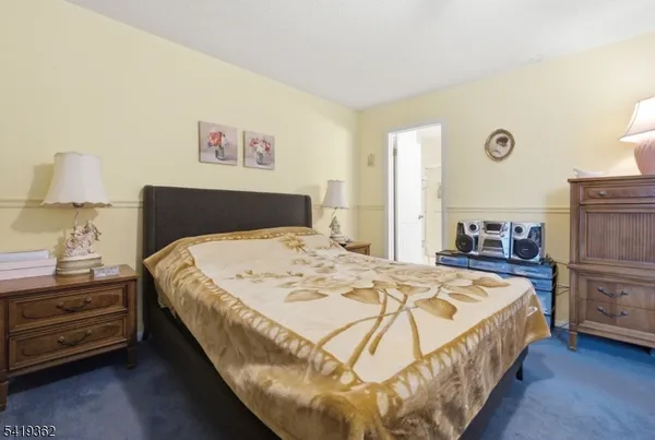 a bedroom with a bed and a lamp