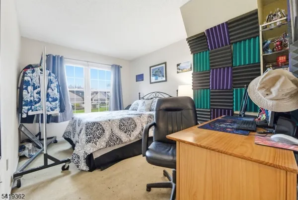 a bedroom with a bed and dresser