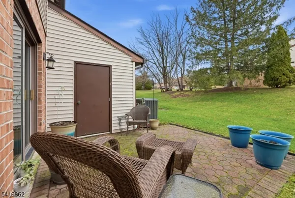a backyard of a house with table and chairs