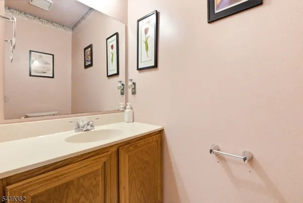 a bathroom with a sink mirror and vanity