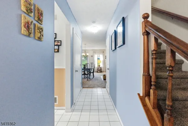 a view of hallway with livingroom and stairs