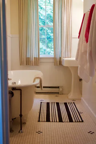 a view of a balcony with wooden floor and furniture