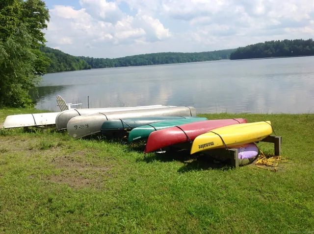 a view of a swimming pool with table and chairs