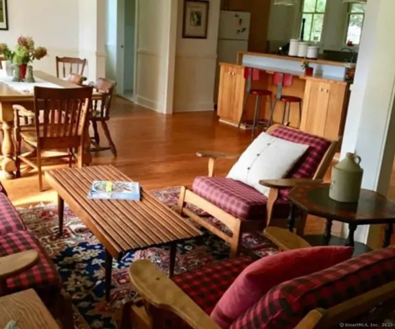 a view of a balcony with furniture and wooden floor