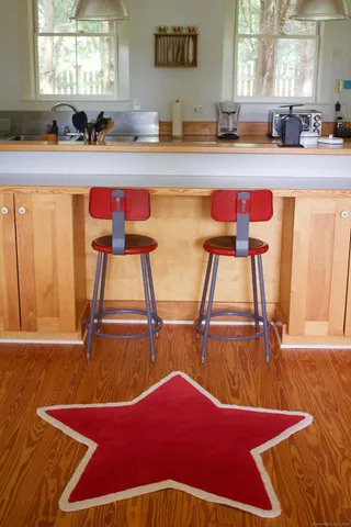 a kitchen with stainless steel appliances kitchen island granite countertop furniture and a window