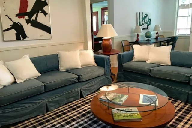 a living room with furniture and a lamp