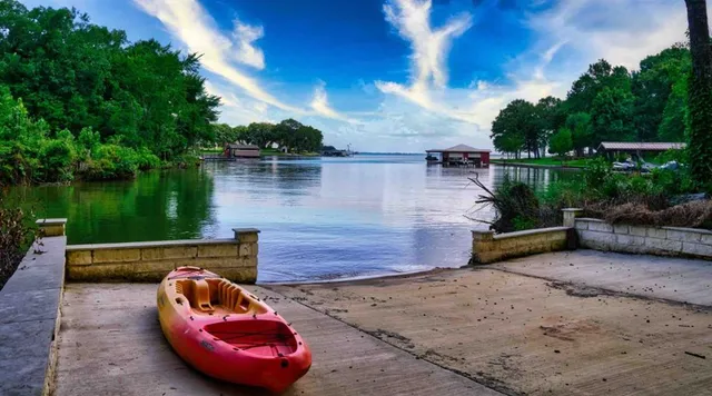a view of a lake with a floor to ceiling window and brick wall
