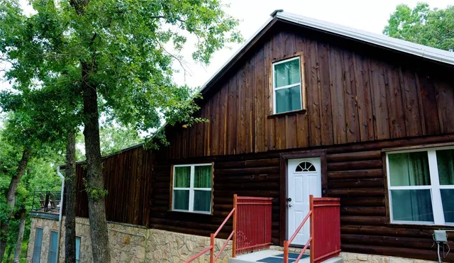 a view of a house with wooden fence