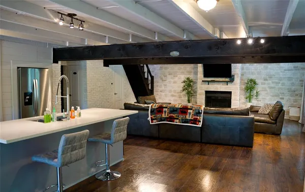 a large room with stainless steel appliances kitchen island granite countertop a sink and cabinets