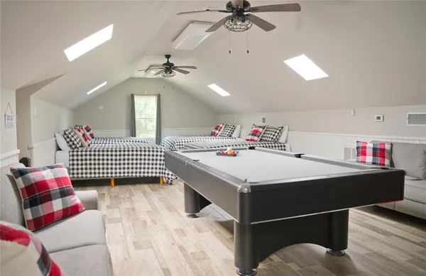 a bedroom with bed and a chandelier